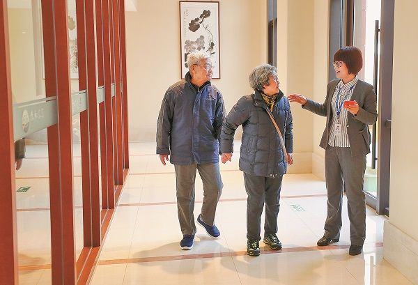 北京一養老社區內,兩名住客與工作人員交談。(中新社資料照片)