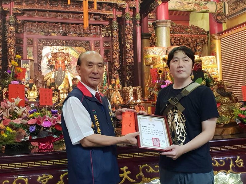 台中南天宮舉辦創意設計徵件活動,主委吳光雄(左)頒獎給獲獎者。(林欣儀攝)